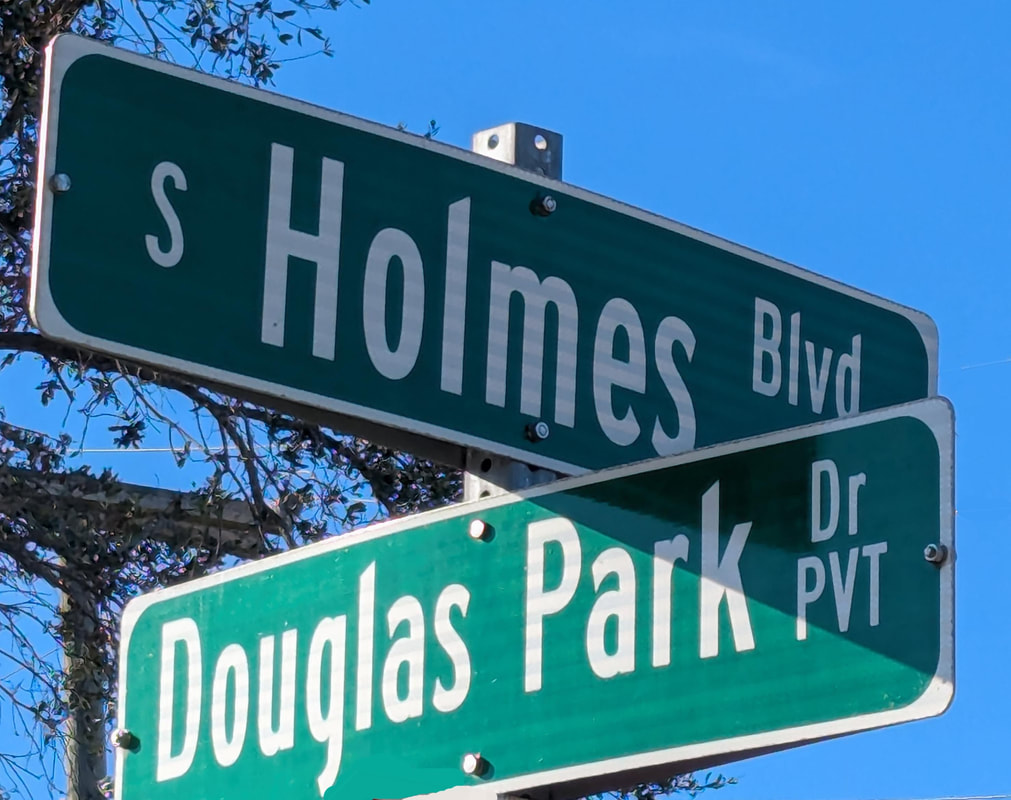 Street sign showing intersection of South Holmes Blvd. and Douglas Park Drive